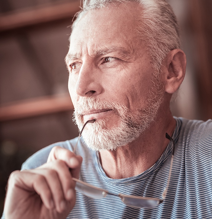 Older man considering dental implant tooth replacement