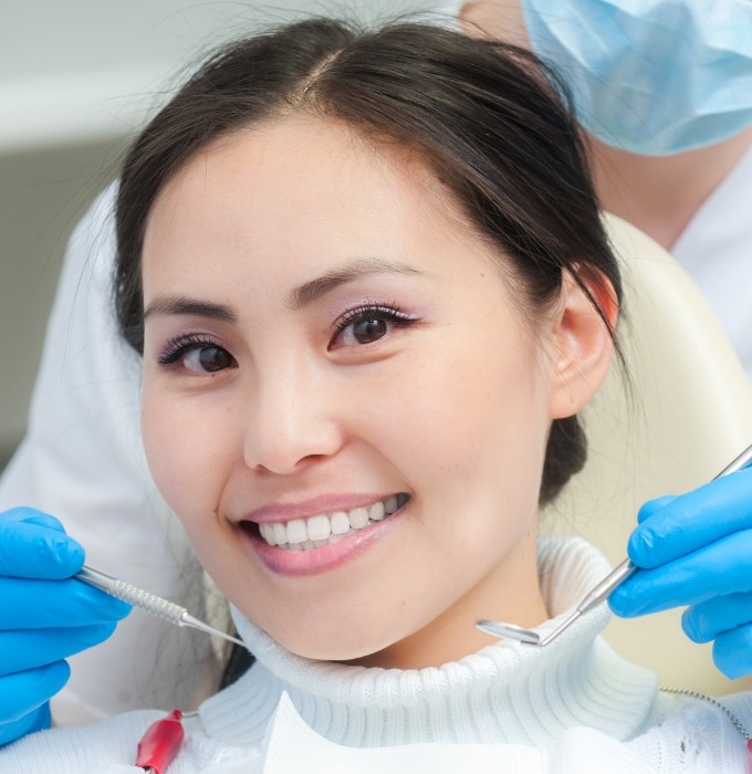 Woman smiling after receiving a one visit dental restoration