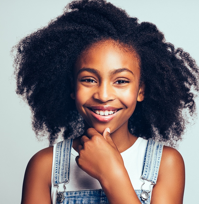 Preteen girl smiling after pulp therapy