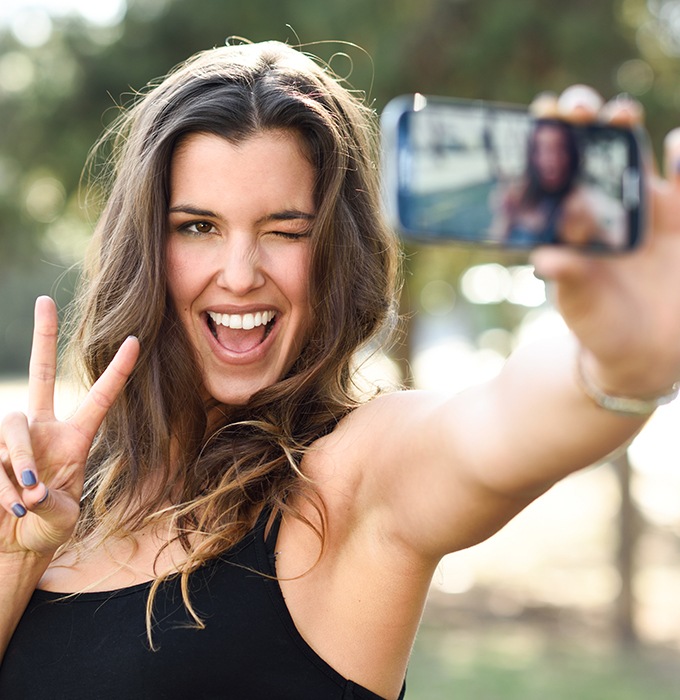 Woman smiling after metal free dental restoration