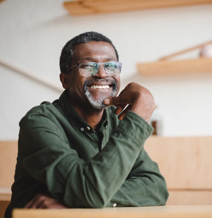 a smiling person sitting down