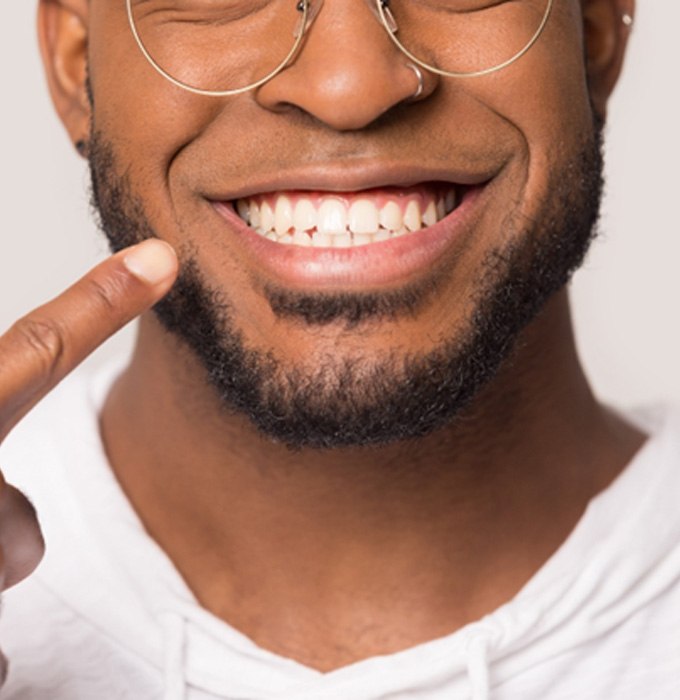 man smiling while getting dental crown 