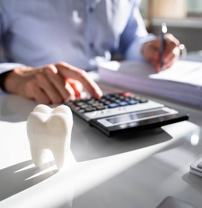 Tooth next to a calculator