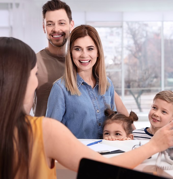 Family and dental team member discuss the cost of treating dental emergencies