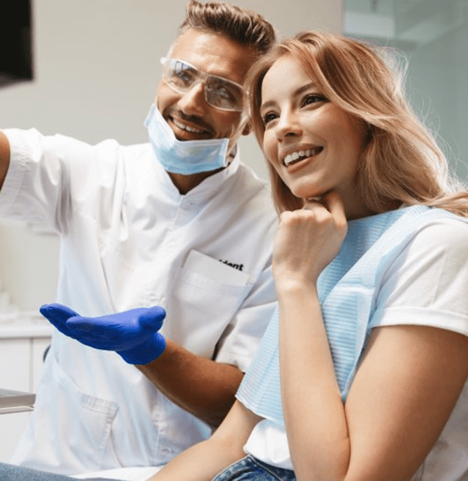 a patient smiling after receiving tooth-colored fillings in Muskegon