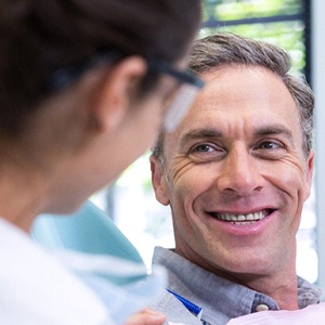 Implant dentist in Muskegon speaking with a patient