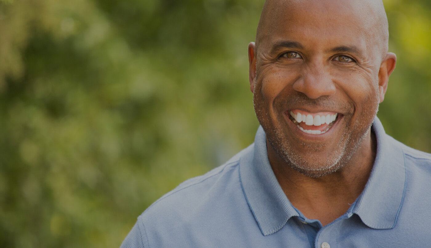 Older man with healthy smile after visiting the dentist in Muskegon