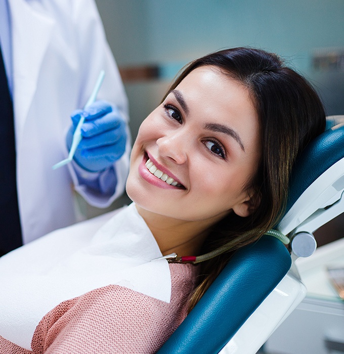 Patient smiling after dental checkup and teeth cleaning visit