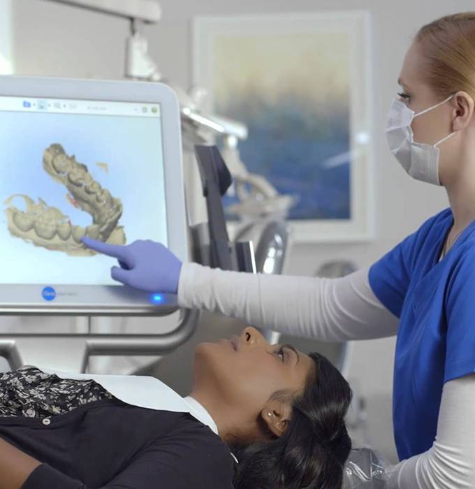 Dentist and patient looking at intraoral images