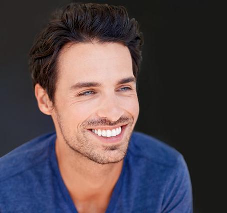 a man smiling after undergoing professional teeth whitening
