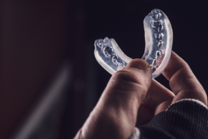 an athlete holding his mouth guard