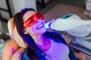 Patient having teeth whitened in dentist's office.